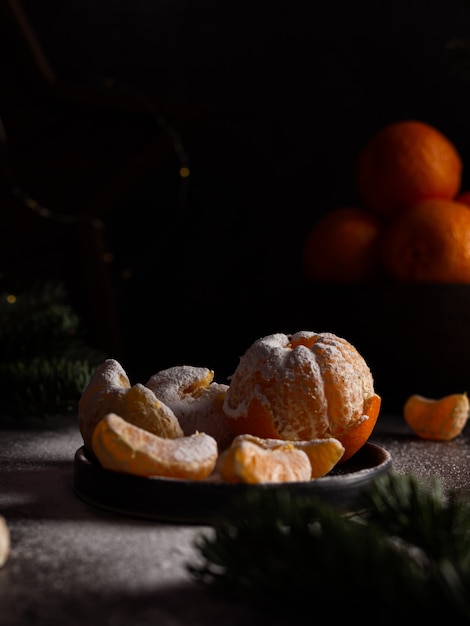 christmas new years composition with tangerines in a plate pine cones