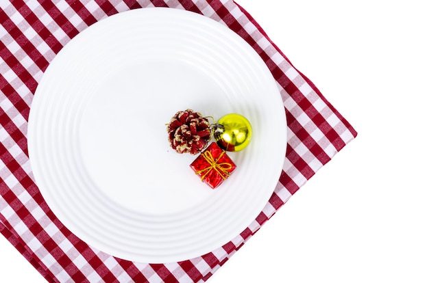 Christmas and New Years concept. White plate, red tablecloth.