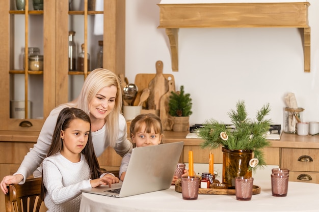 christmas online. two little girls are watching a laptop. Concept christmas time