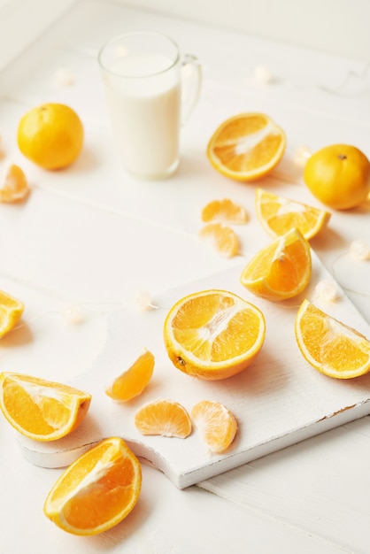 Christmas oranges and tangerines on a white by the window