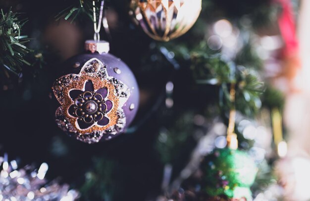 Christmas ornaments bauble on tree with blurry light background Xmas ball on the branches firHorizontal banner for Merry ChristmasHappy New Year greeting card Noel Winter Holidays Concept