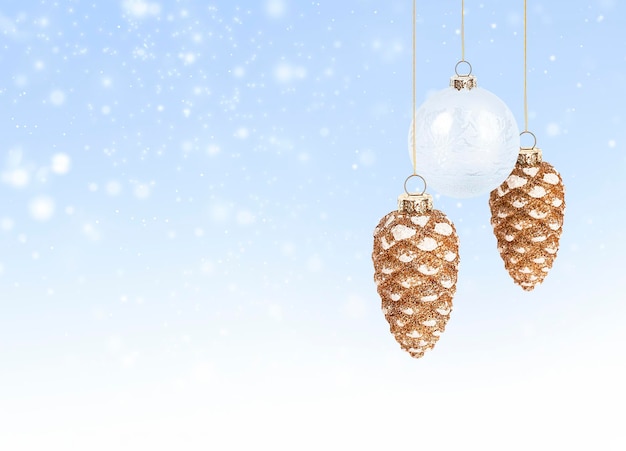 Christmas ornaments in the form of cones and balls hang on a blue background