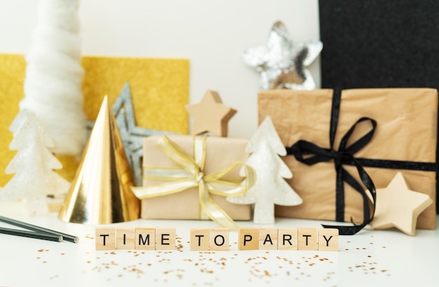 Christmas party time - confetti, gifts, tree, stars, glitter, ribbon. Party time lettering. New year 2022.