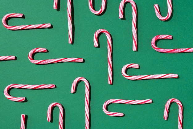 Christmas pattern of candy cane on green background