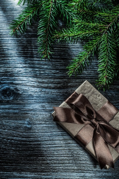 Christmas present box fir branches on wooden board