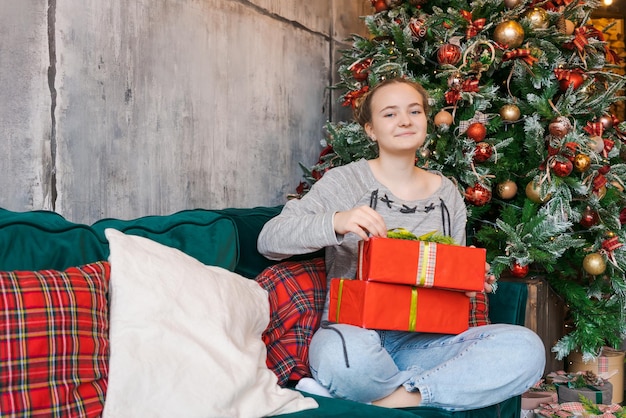 Christmas present in hands Happy woman at home holding christmas and new year