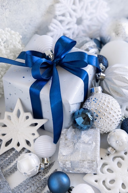 Christmas present with blue bow and silver decorations closeup