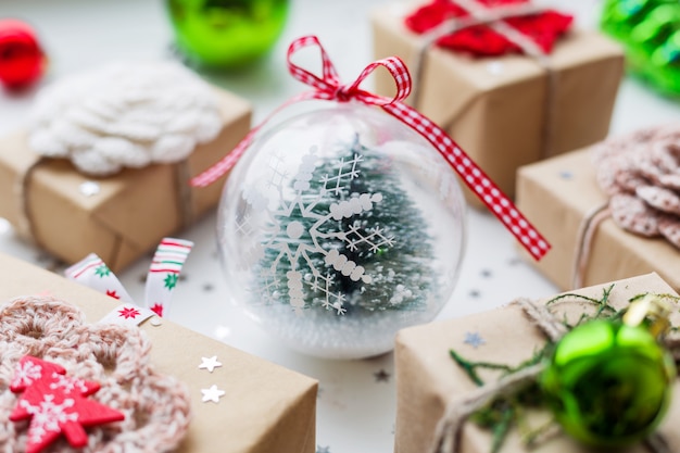 Christmas    presents, decorations and transparent decorative ball  fir tree inside.