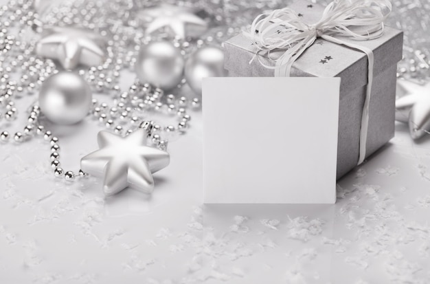 Christmas presents with silver ribbon on white wooden background