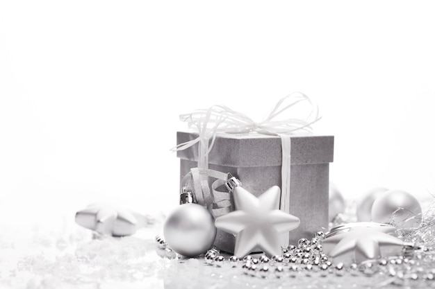 Christmas presents with silver ribbon on white wooden background