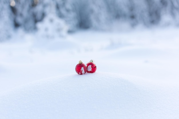 christmas red balls with long shadows  in fresh snow on beautiful sunny winter day