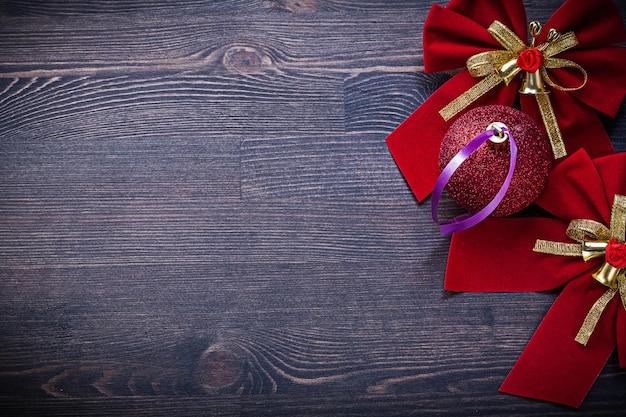 Christmas red bows ball on wooden board holidays concept