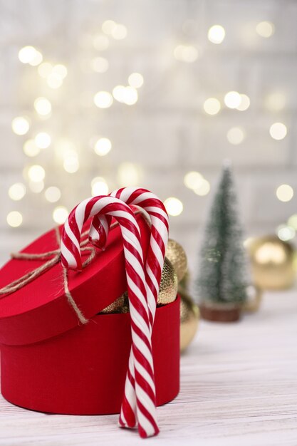 Christmas red gift box Decoration with Candy Canes on bokeh