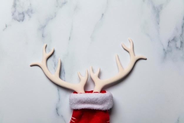 Christmas reindeer antlers and stocking on a marble background