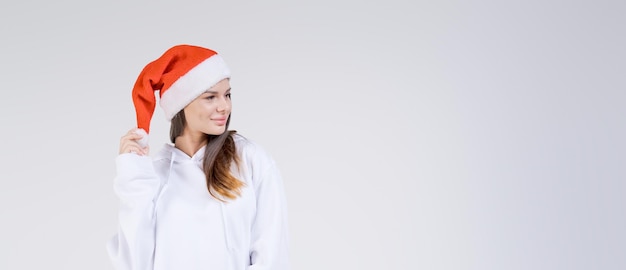 Christmas sale Beautiful surprised young millennial girl wearing santa claus