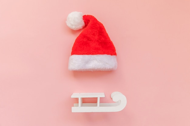 Christmas Santa Claus hat sled isolated on pink pastel colorful trendy background