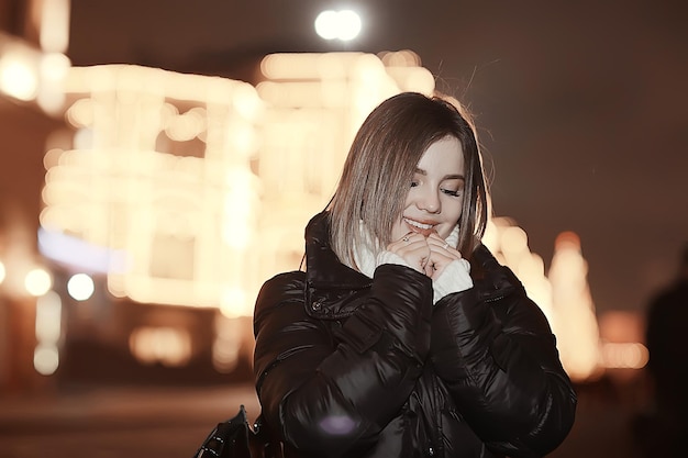 Christmas shopping girl city, young model evening gift shopping, seasonal sale, winter evening outside in the city