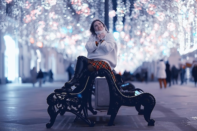 Christmas shopping girl city, young model evening gift shopping, seasonal sale, winter evening outside in the city