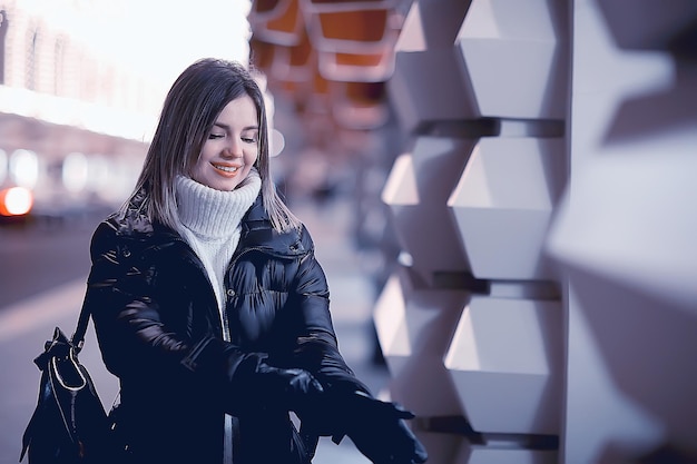 Christmas shopping girl city, young model evening gift shopping, seasonal sale, winter evening outside in the city