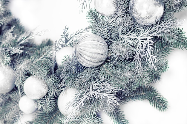 Christmas silver wreath decorations close up on light background.