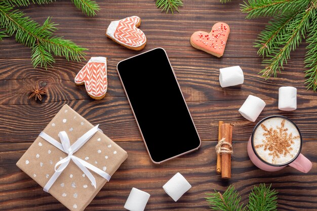 Christmas smartphone and present on wooden background