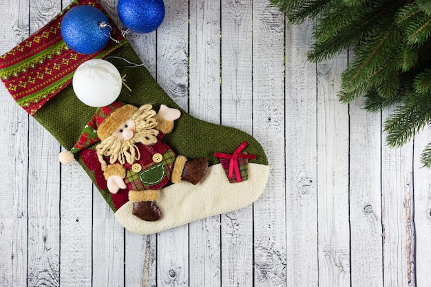 Christmas sock with a gnome, Christmas decoration on a wooden table