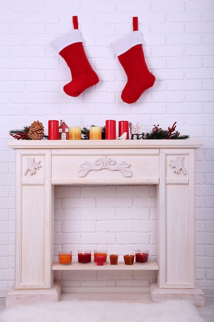 Christmas socks hanging on wall above fireplace