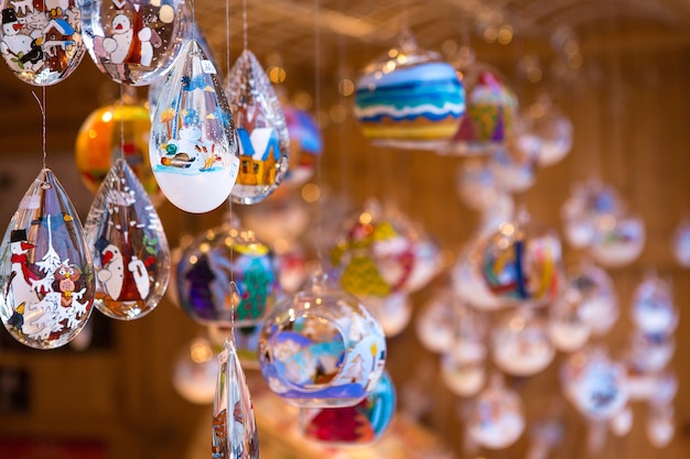 Photo christmas souvenirs on the counter in europe, painted glass christmas balls with fairy tales.