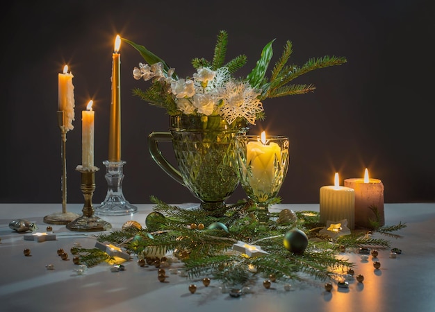 Christmas still life with branch of fir candles and lights