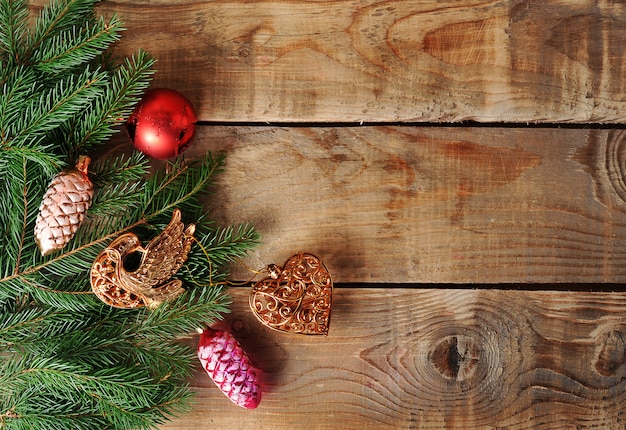 Christmas surface toys on the Christmas tree on wooden surface