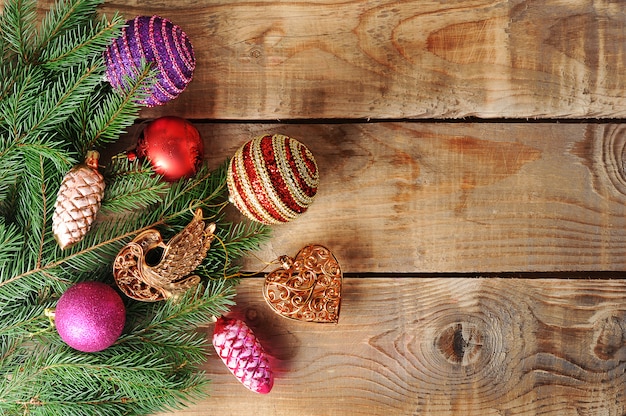 Christmas surface toys on the Christmas tree on wooden surface