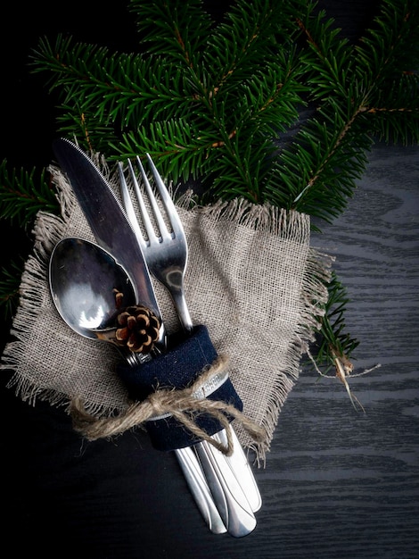 Christmas table setting in silver tone on wooden table