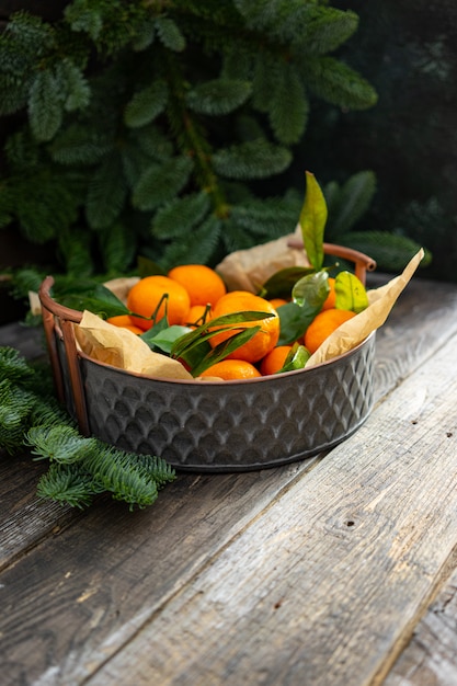 Christmas tangerine vintage copper bowl and fir branches.