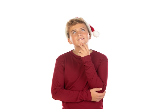 Christmas teen boy in Santa red hat isolated on white background