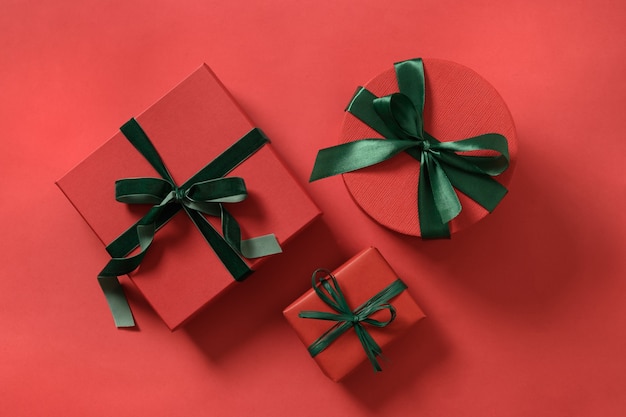 Christmas three gifts on red surface.