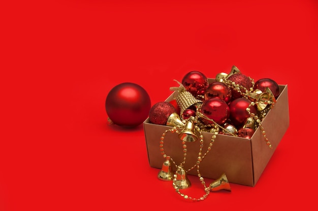 Christmas toys in a box on a red background with copy space greeting card