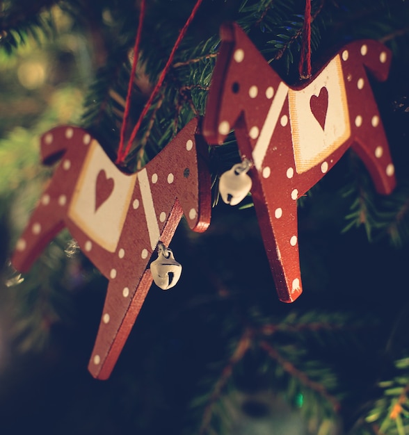 Christmas toys hang on the branches of the Christmas tree.