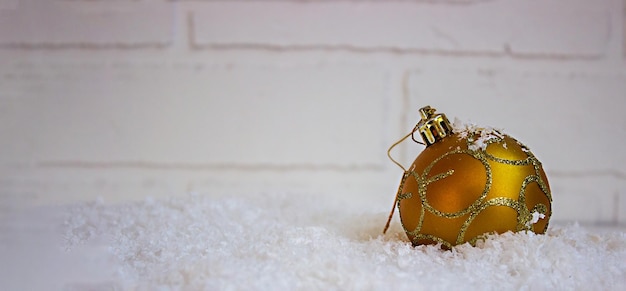 Christmas toys on a light background in artificial snow