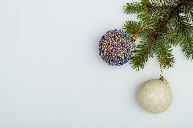 Christmas toys on pine branch with copy space on white background