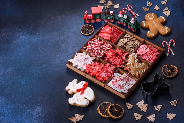 Christmas toys in white and red in a wooden sectional box against a dark concrete background