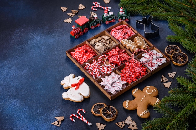 Christmas toys in white and red in a wooden sectional box against a dark concrete background