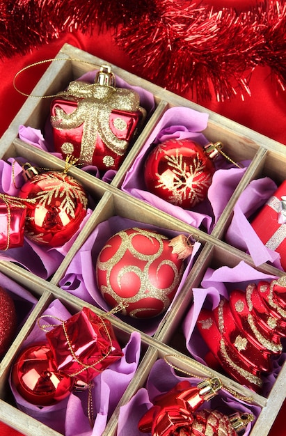 Christmas toys in wooden box on bright background