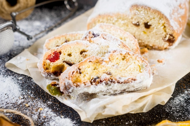 Christmas traditional fruit bread stollen with dried berries nuts and powdered sugar