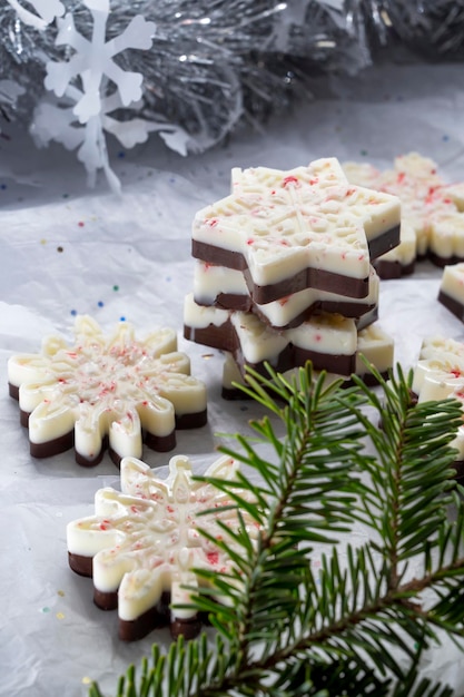 Christmas treat or gift. Homemade peppermint bark in snowflake shape, white and dark chocolate