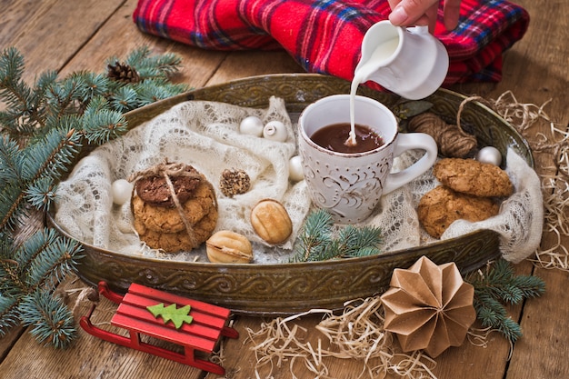 Christmas treats and decor. Milk pouring into a mug