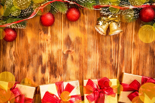 Christmas tree branch with decorations on wood background. Xmas holiday concept