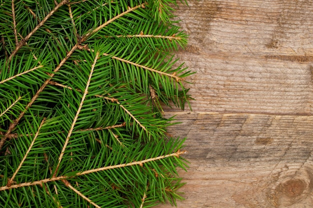 Christmas tree branches on wooden planks