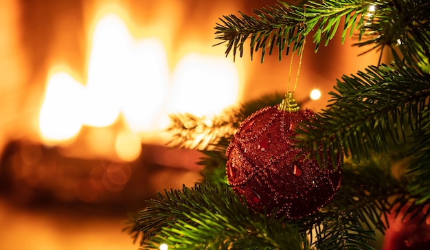 Christmas tree close up on blur fireplace background