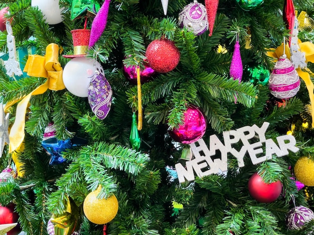 Christmas tree decorated with multicolored balls and snowmen with Happy new year signs and lights.Christmas tree decorated with multicolored balls and snowmen with Happy new year signs and lights.