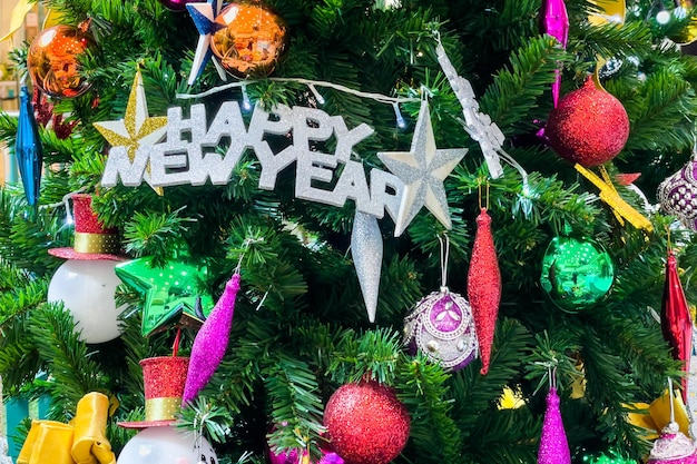 Christmas tree decorated with multicolored balls and snowmen with Happy new year signs and lights.Christmas tree decorated with multicolored balls and snowmen with Happy new year signs and lights.